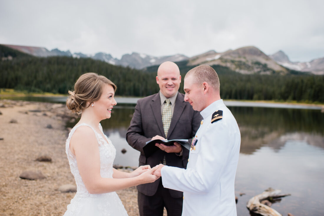 wedding ceremony by the lake with mountains in the background