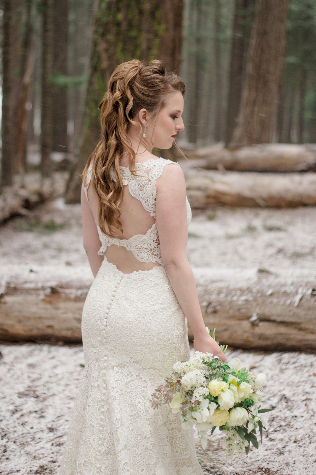 bride in lace dress in the mountains