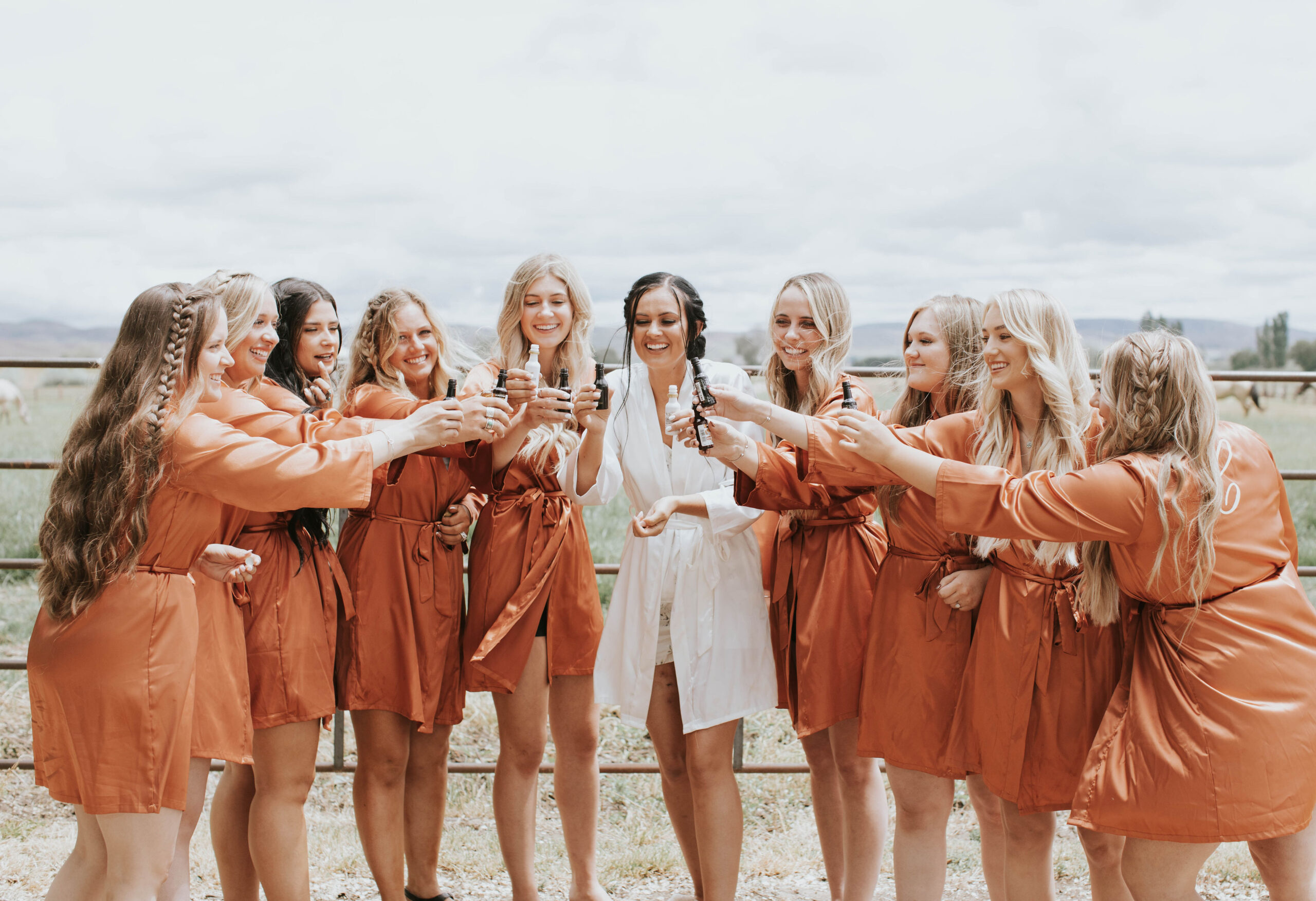 bride and bridesmaids in burnt orange robes