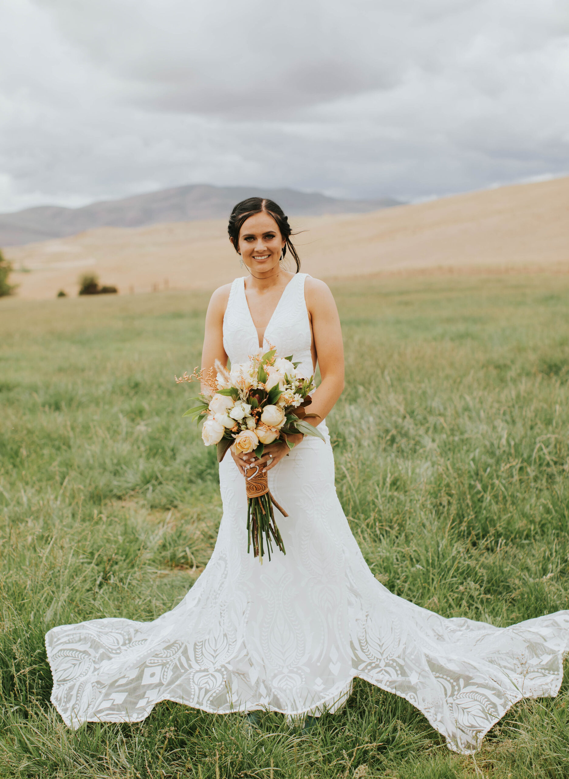 bride in lace wedding gown holding bouquet