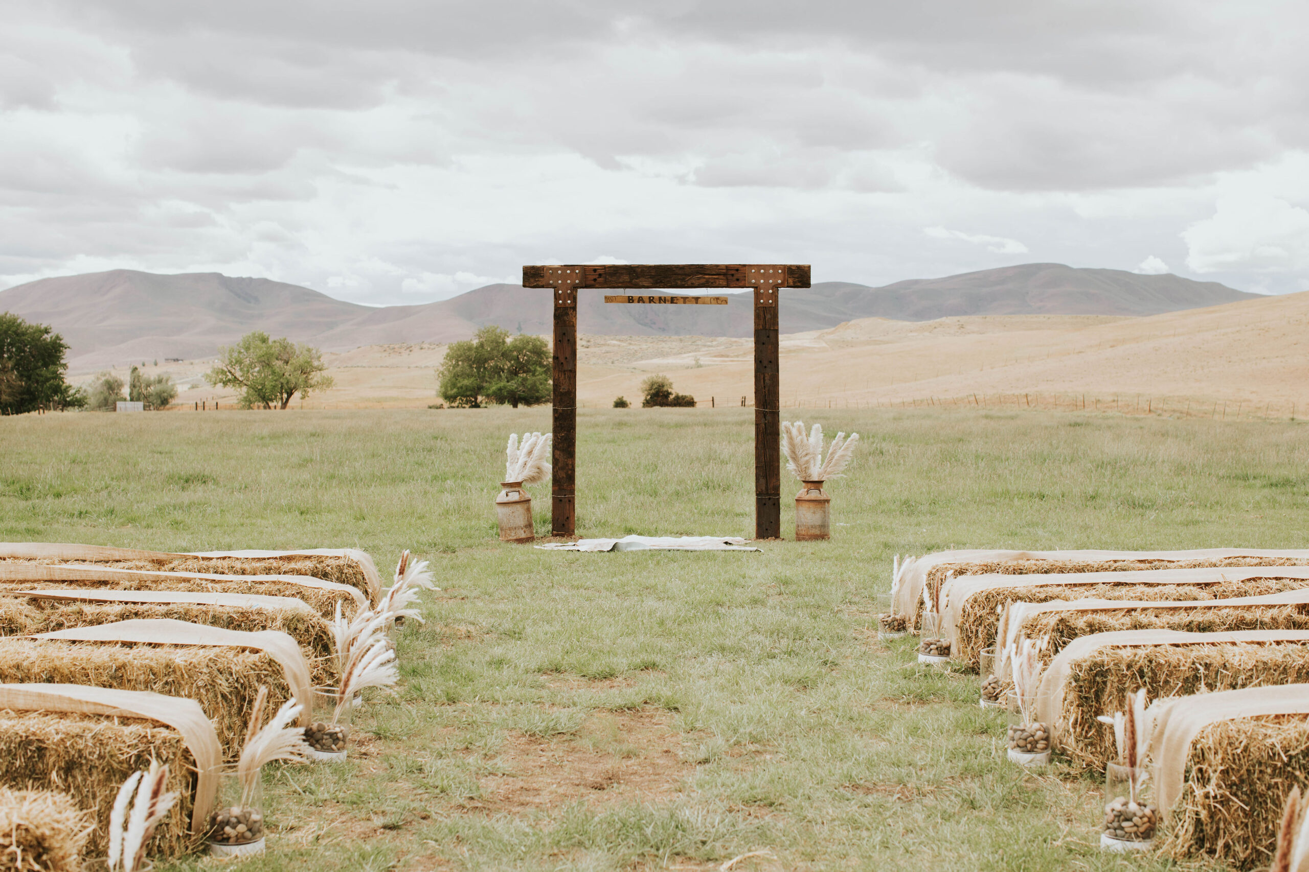 rustic wedding set up with hay as seats