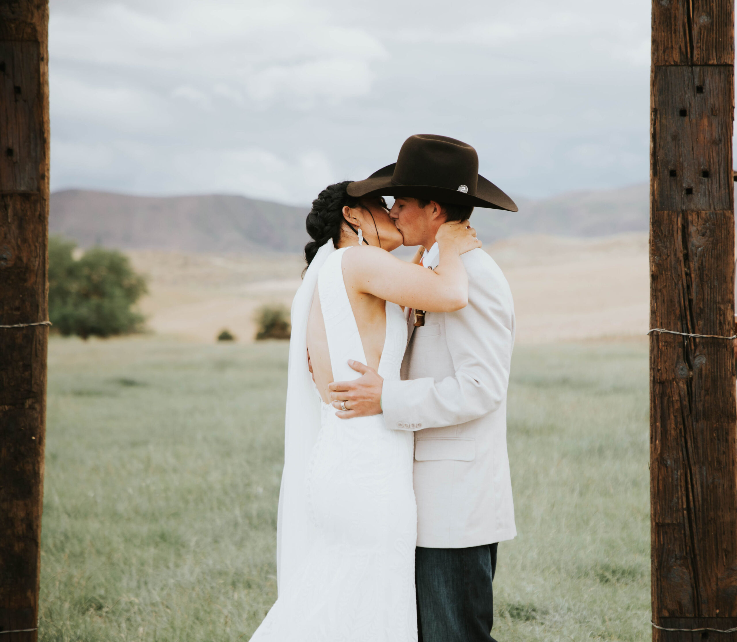 bride and groom kissing at the alter in a rustic mountain wedding
