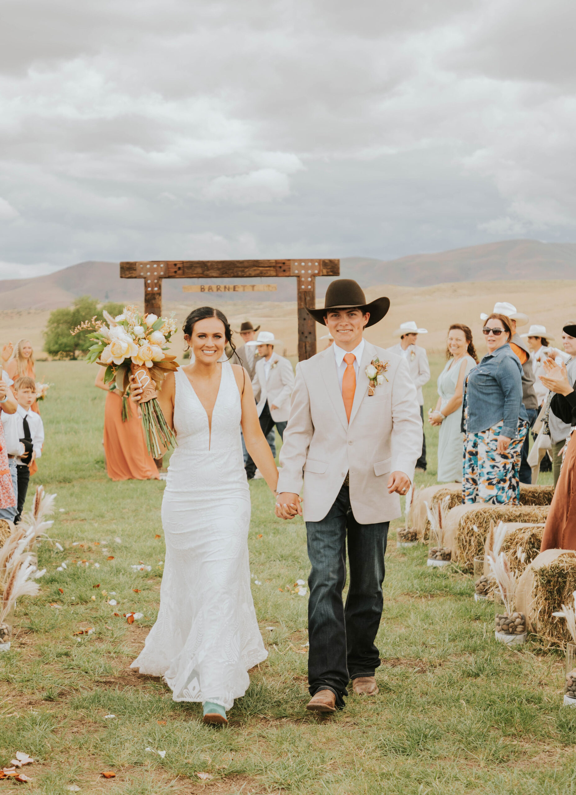 bride and groom walking down aisle in a rustic mountain wedding
